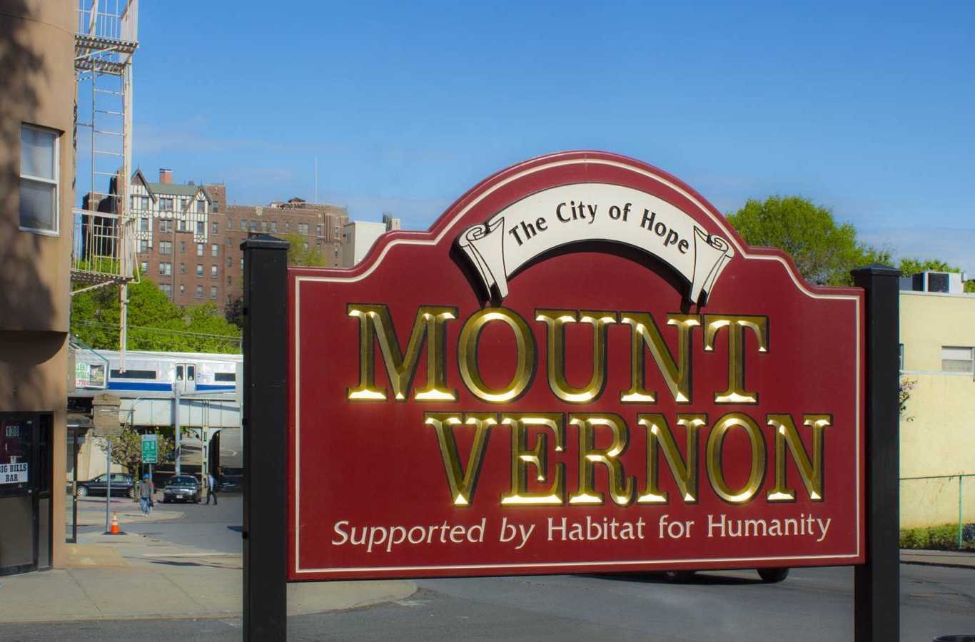 A large Hiep Sanitation dumpster during a community clean-up event in Mount Vernon, NY, emphasizing community and environmental care.