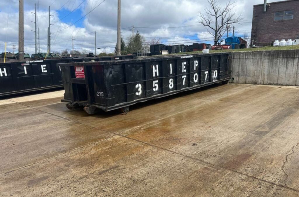A customer interacting with a Hiep Sanitation employee during a dumpster rental process in Westchester County, displaying ease of service and customer satisfaction, Dumpster Rental Near Me.