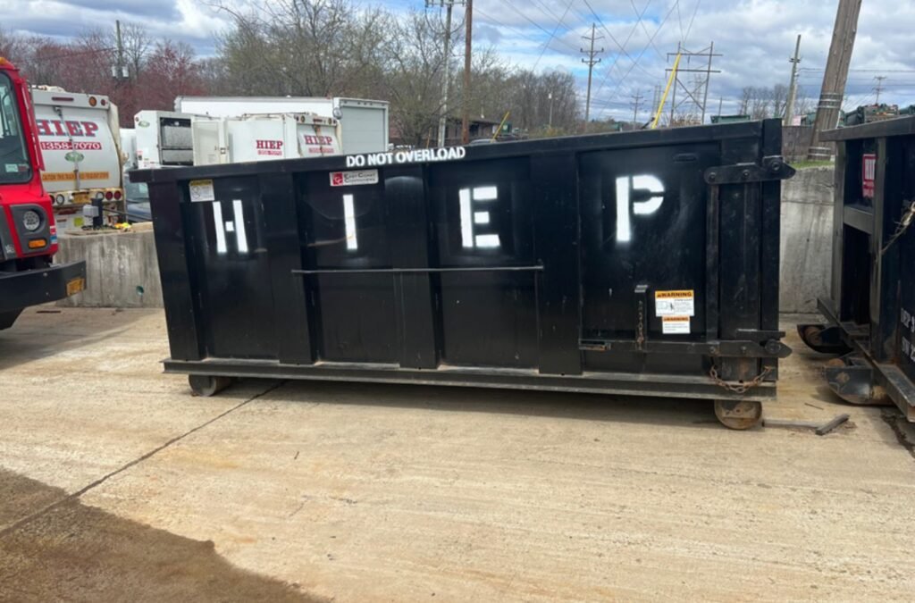 A Hiep Sanitation team member delivering construction dumpster rental in Tappan, NY, demonstrating the benefits of using a local professional for this essential service.