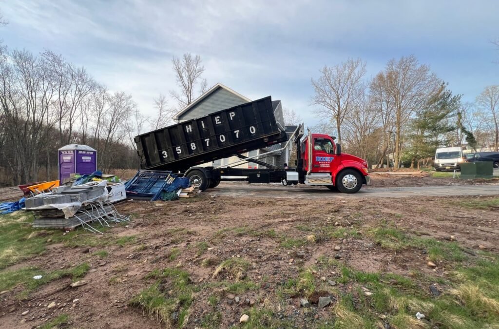 Hiep Sanitation professional loading trash into truck in Tappan, NY, showing trusted service and community-focused waste solutions. Trash Services near me.