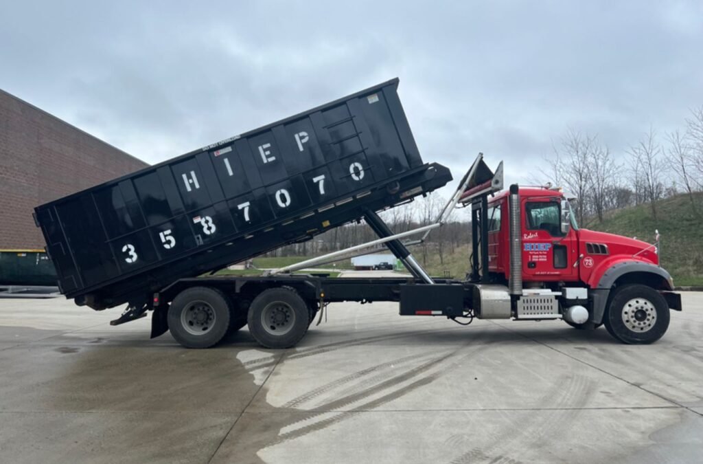 Hiep Sanitation team setting up dumpster rental in Middletown, NY to show efficient and eco-friendly waste handling.